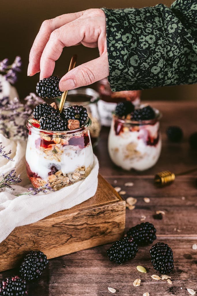 A delicious blackberry yogurt parfait with granola, captured in a beautiful food setup.