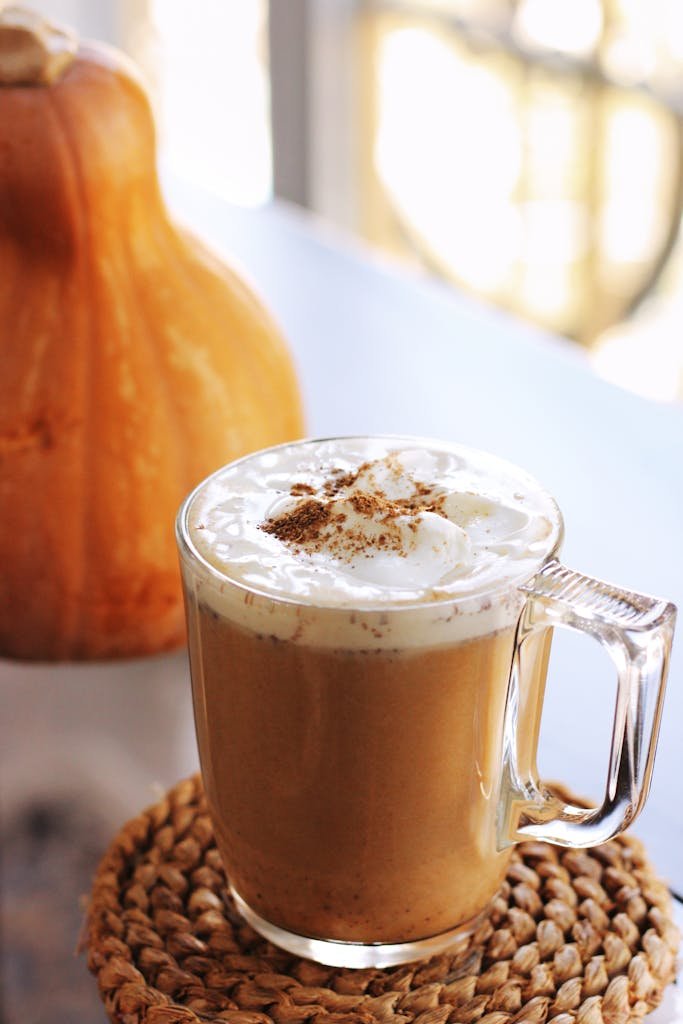 Delicious pumpkin spice latte topped with whipped cream, perfect for autumn indulgence.