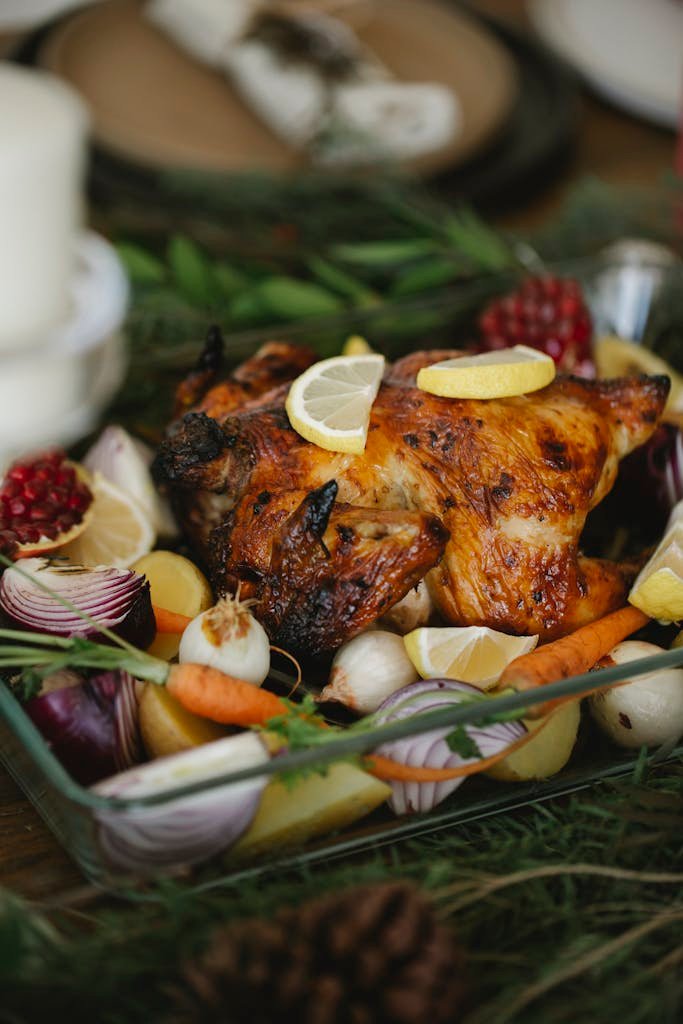Delicious Christmas roast chicken surrounded by fresh vegetables, perfect for a holiday feast.